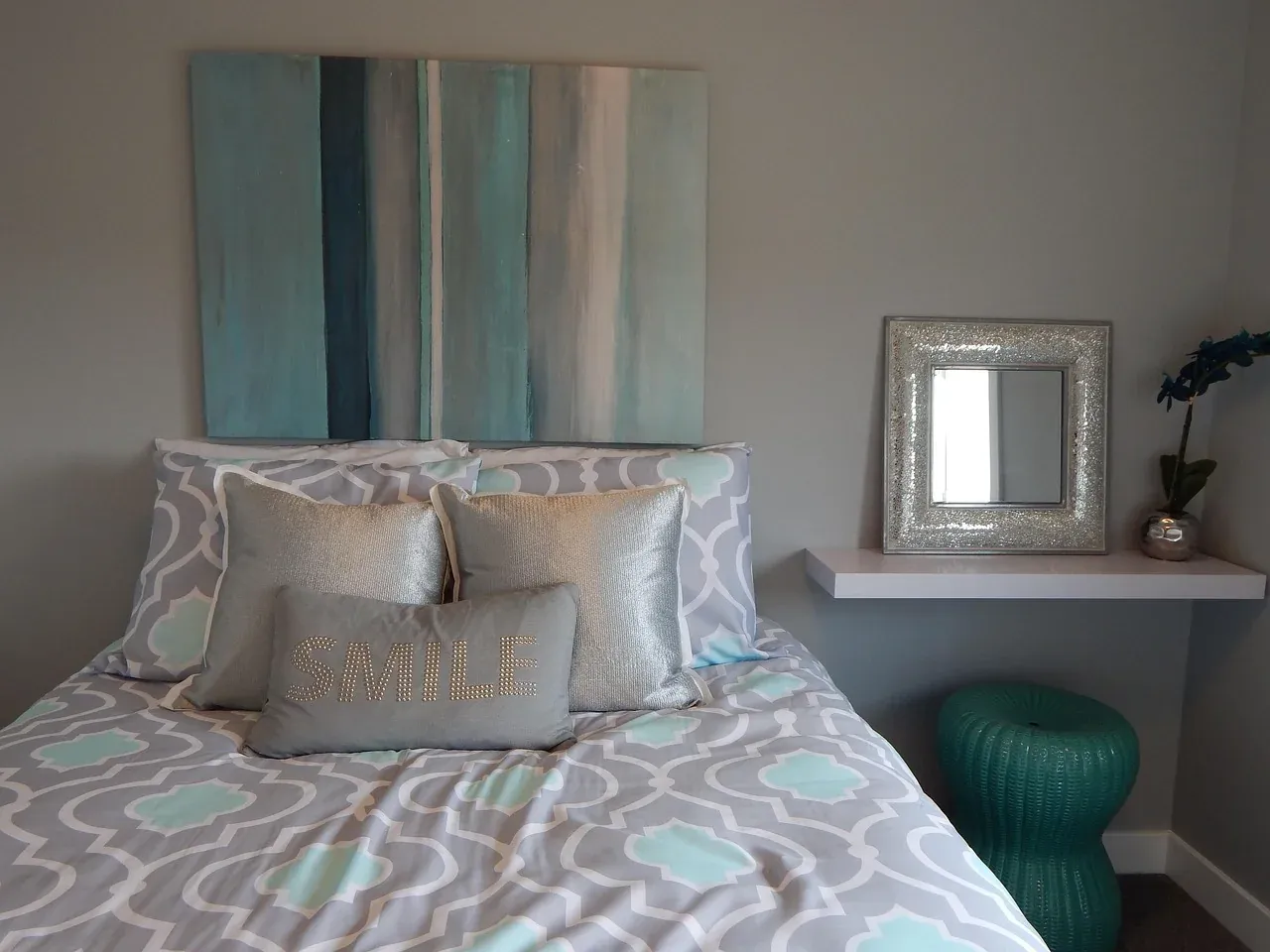 Bed with patterned pillows and a soft cover