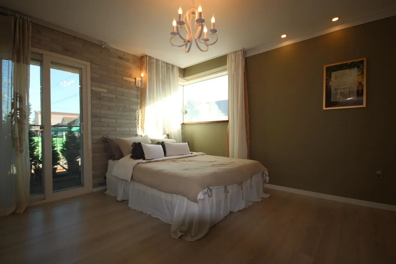 Bedroom with layered pillows and warm lighting