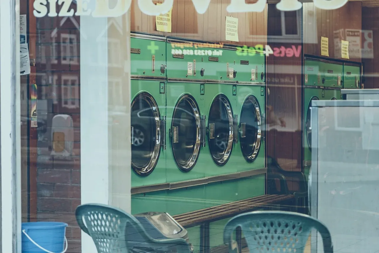 Washing machines seen through a laundrette window