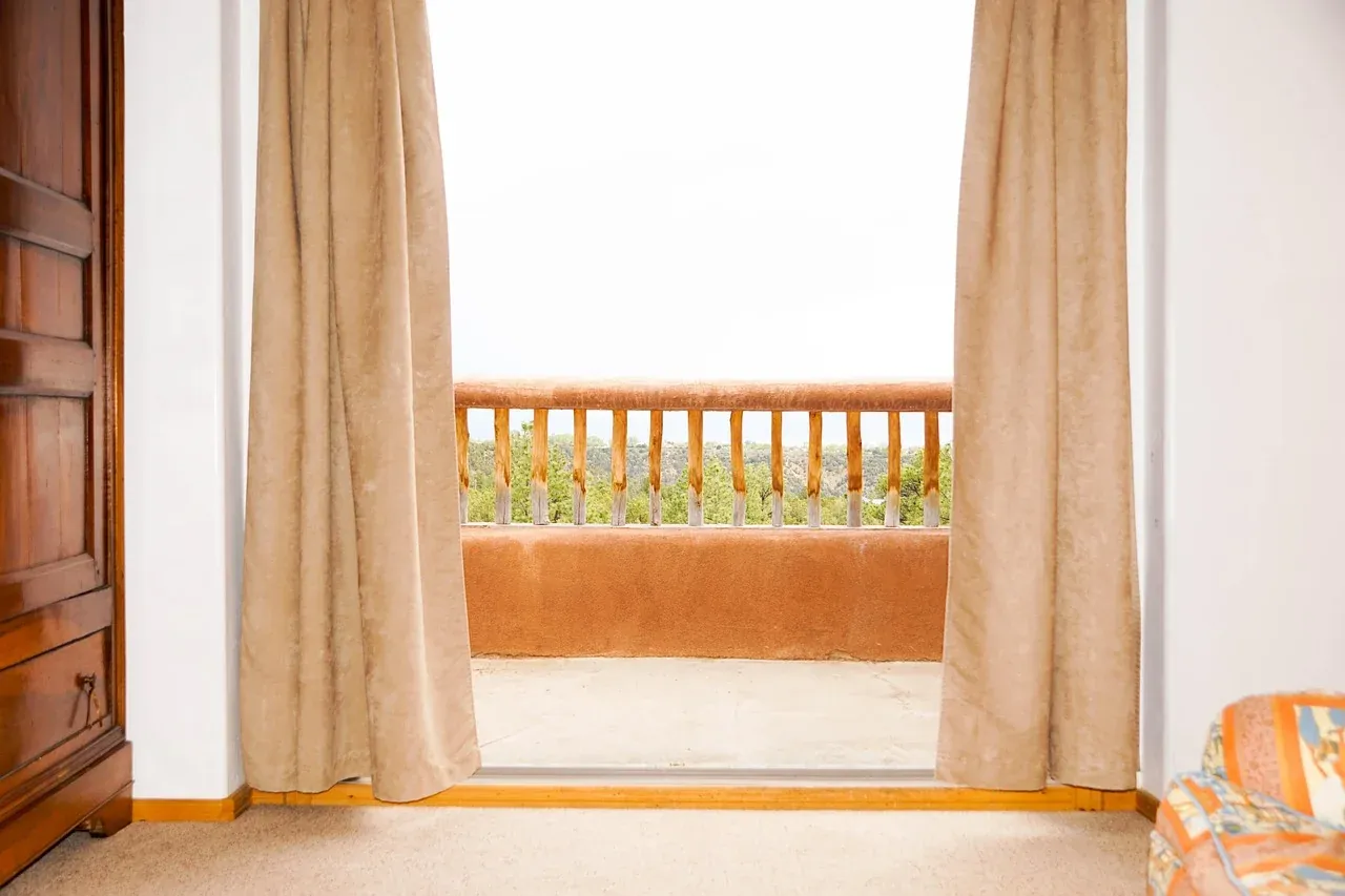 Curtains framing a bright open window