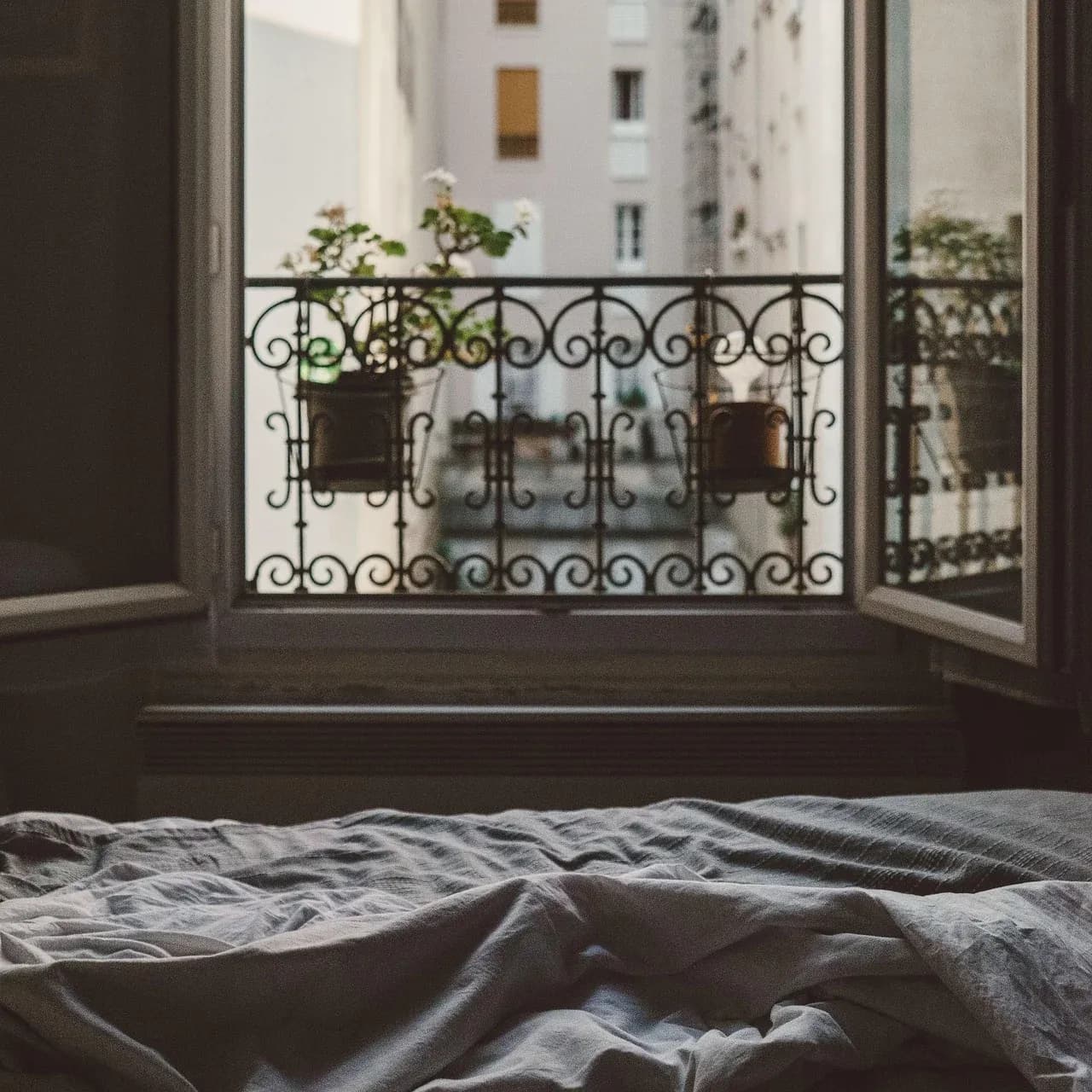 Open window with a decorative iron balcony railing