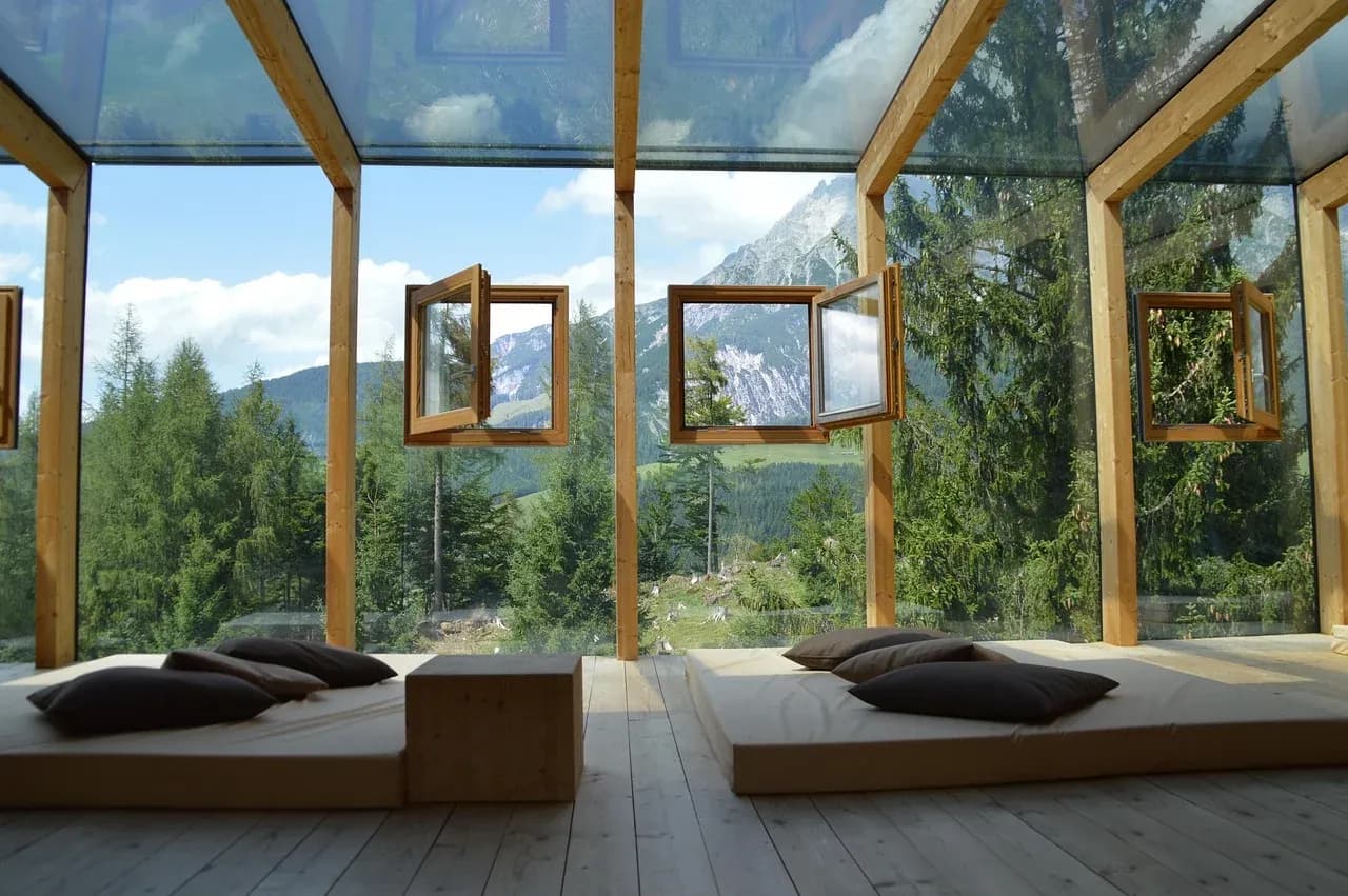 Large windows beside low beds in a sunlit room