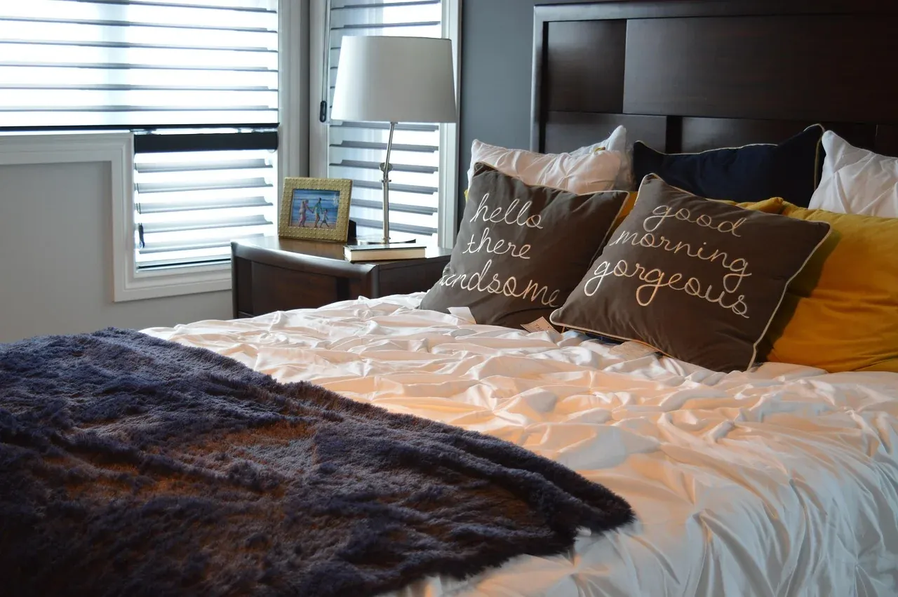 Layered duvet and cushions on a made bed