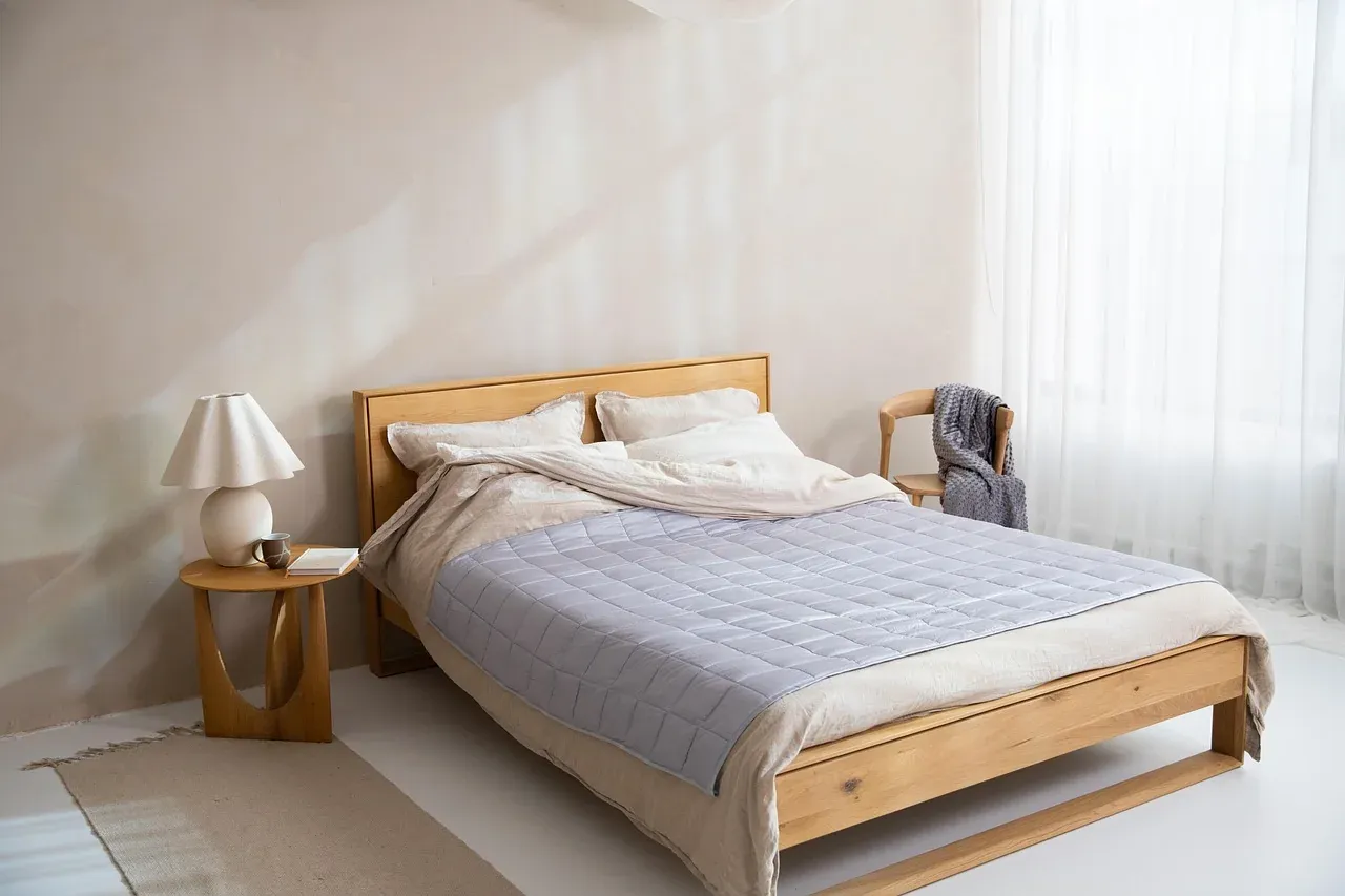 Made bed with a pale quilted cover
