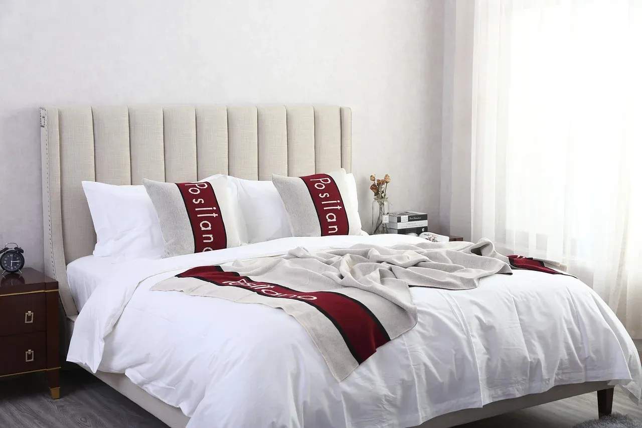 White bedding with red accent cushions