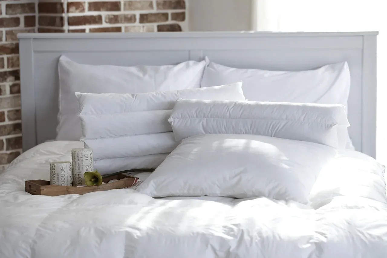 White pillows resting against a grey headboard