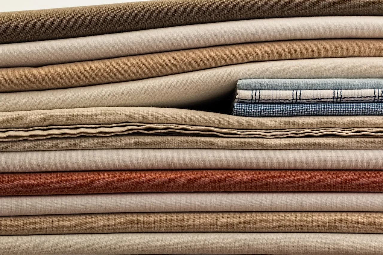 Stack of folded neutral-coloured fabrics