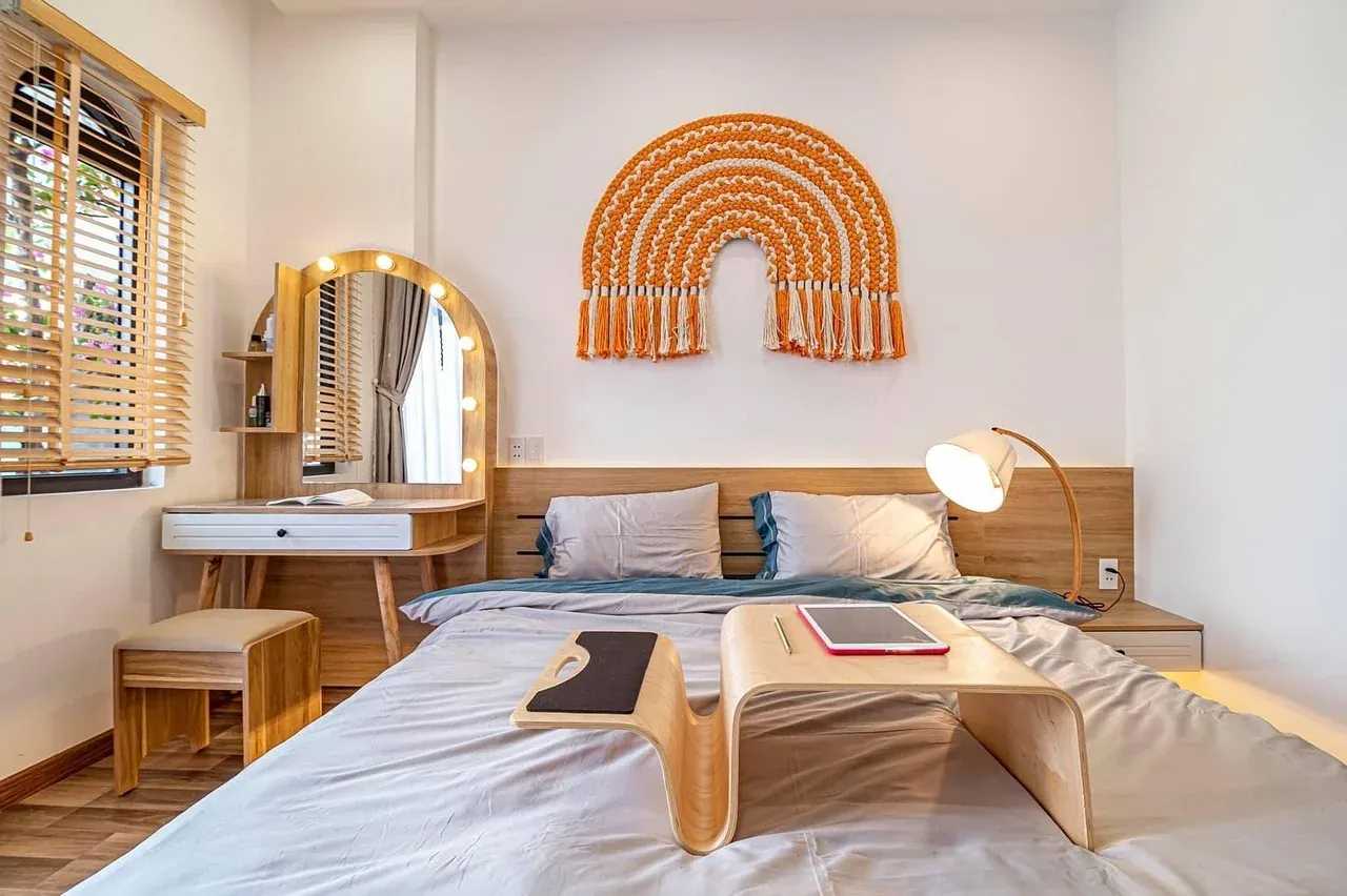 Bedroom with white linen and an arched wall decoration