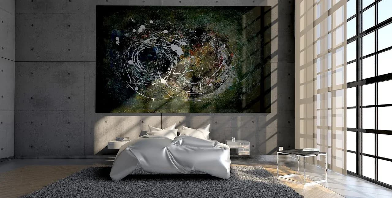 Light falling across a bed beside tall windows