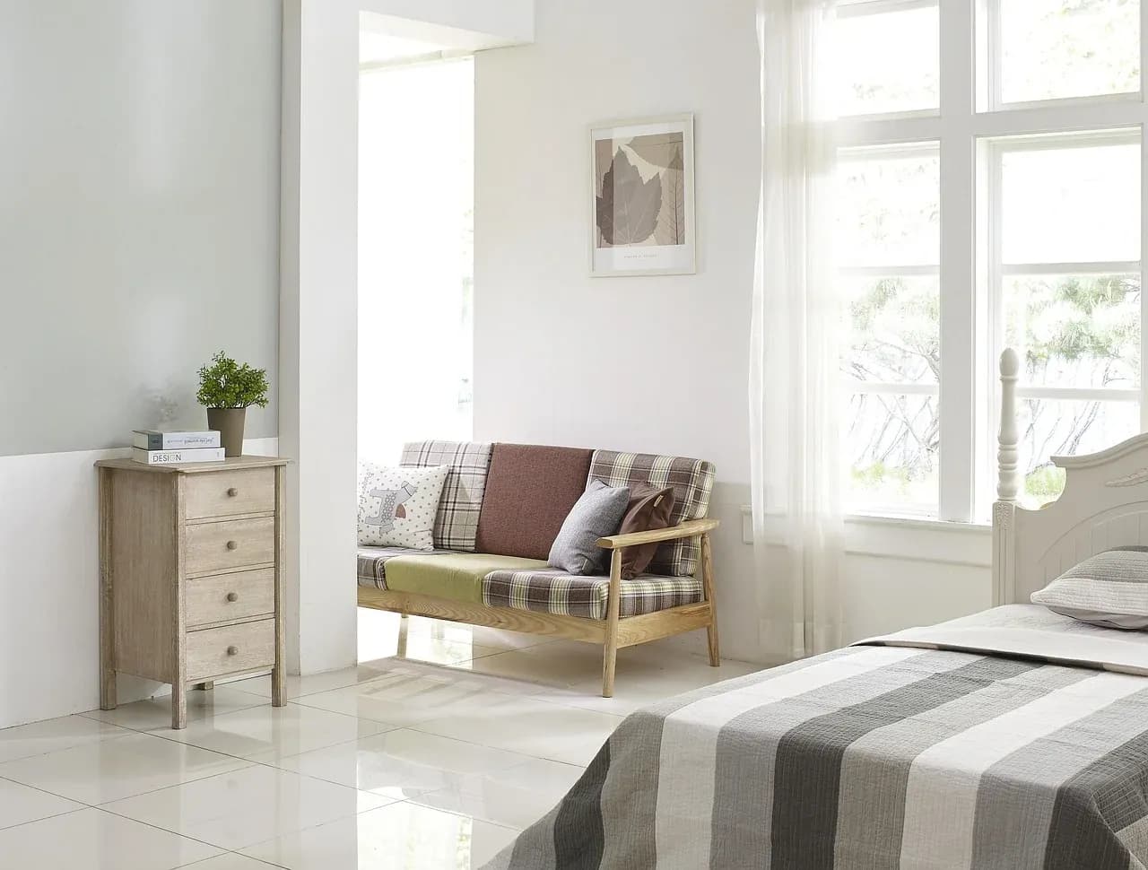 Bright bedroom with a neutral duvet and cushions