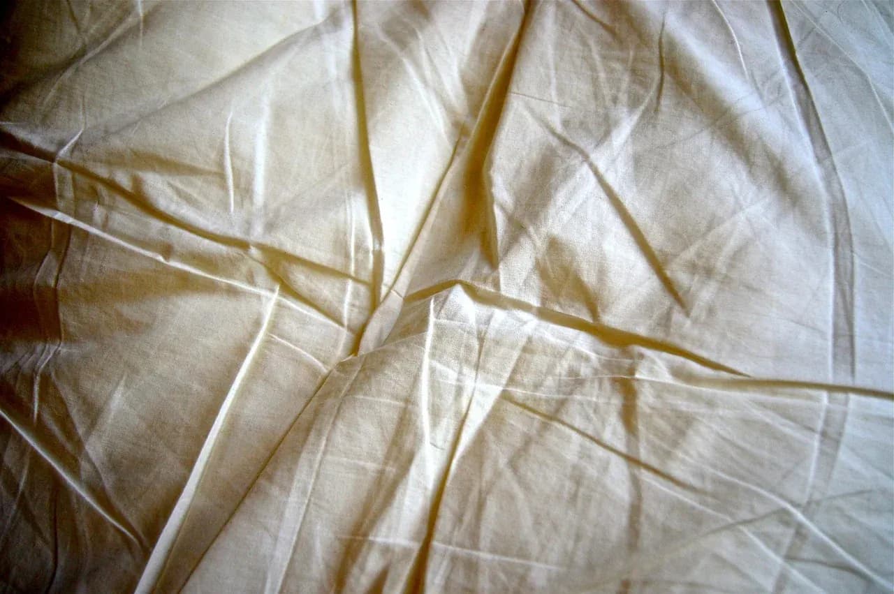 Close-up of folds in a pale fabric