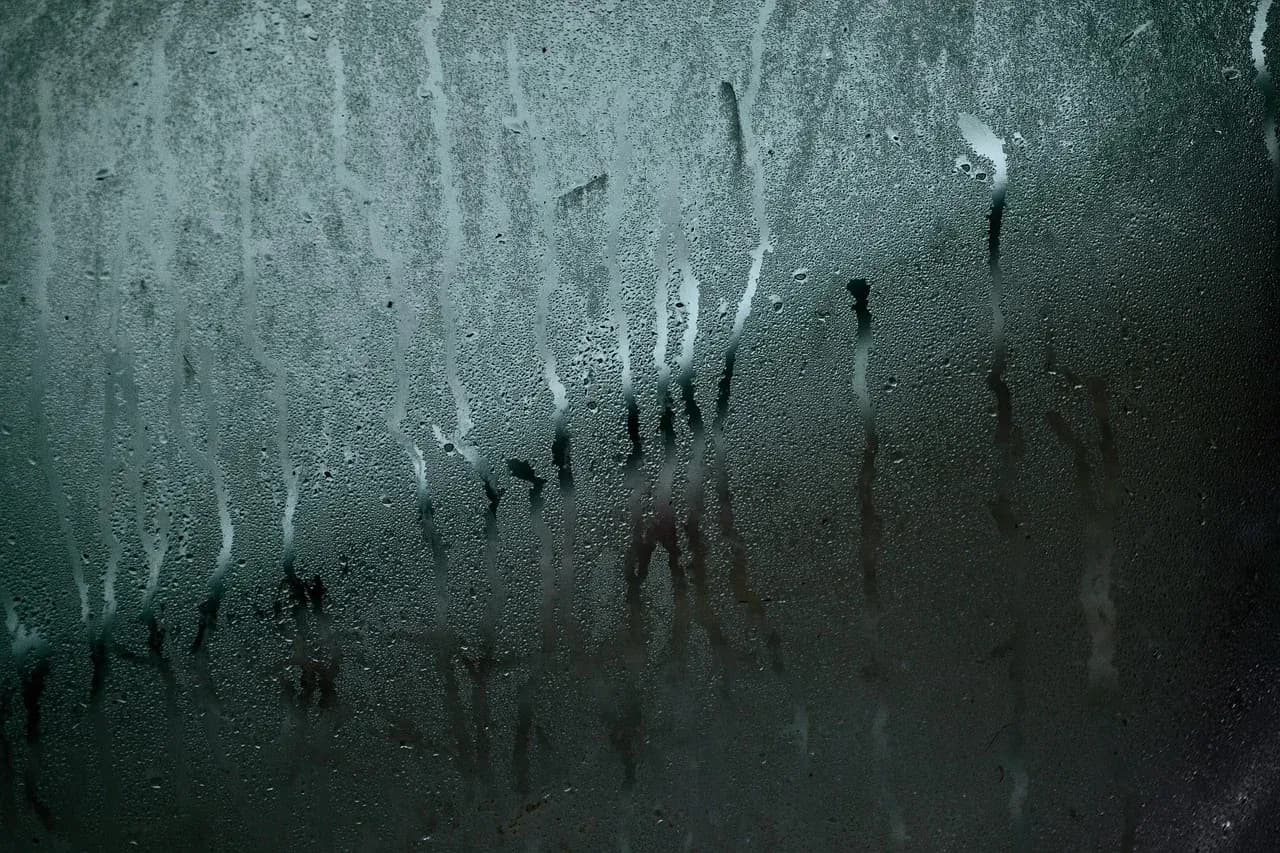 Moisture streaks and droplets on window glass