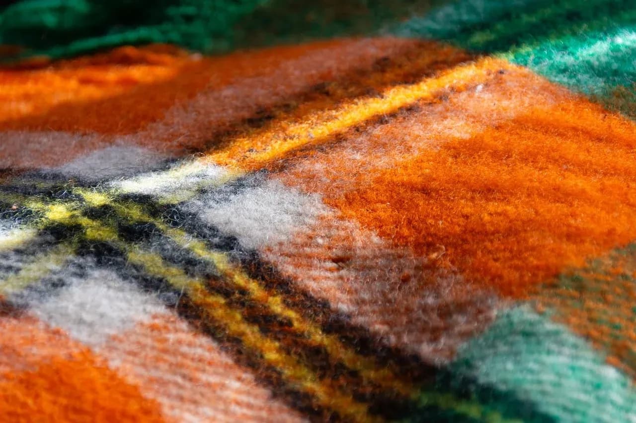 Close-up of an orange and green checked blanket